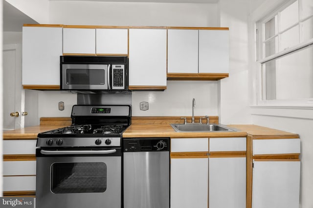 560 25th Pl NE, Washington, DC 20002 - kitchen featuring a sink, light countertops, stainless steel appliances, and white cabinetry