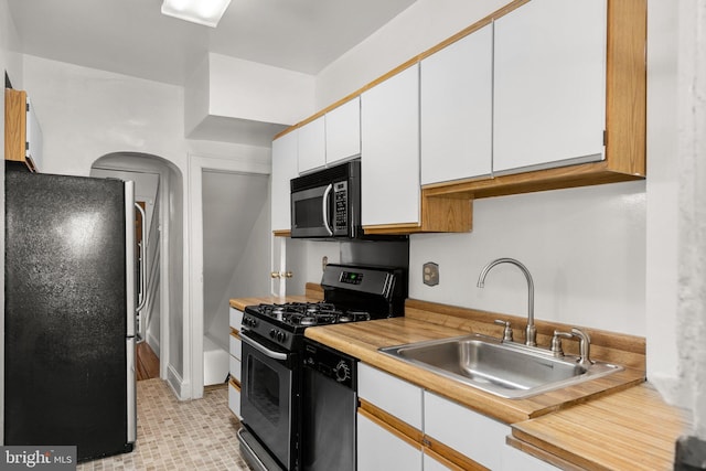 560 25th Pl NE, Washington, DC 20002 - kitchen with light countertops, stainless steel appliances, white cabinetry, and a sink