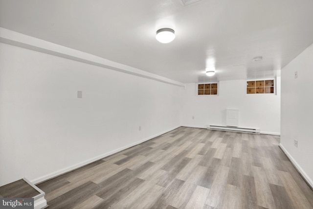 560 25th Pl NE, Washington, DC 20002 - finished below grade area featuring baseboards, wood finished floors, and a baseboard radiator