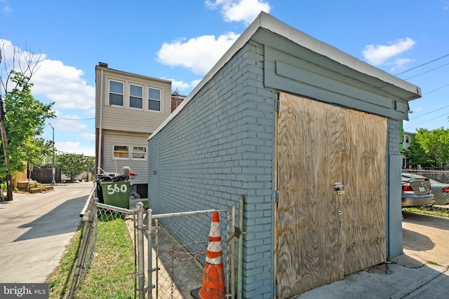560 25th Pl NE, Washington, DC 20002 - view of home's exterior featuring fence, a gate, an outdoor structure, and a shed