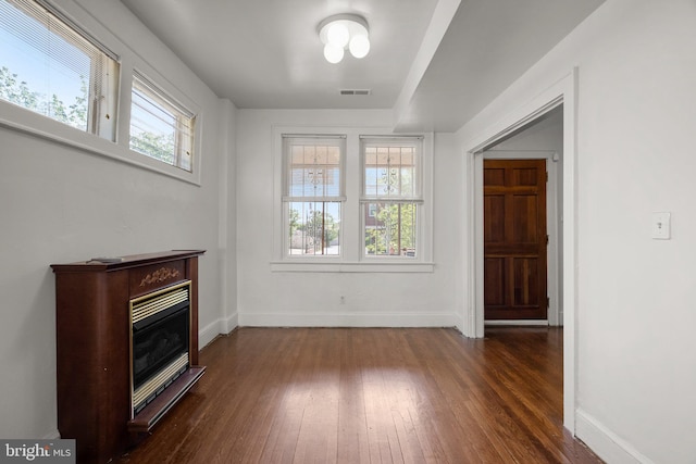560 25th Pl NE, Washington, DC 20002 - interior space featuring a glass covered fireplace, baseboards, dark wood-style flooring, and visible vents