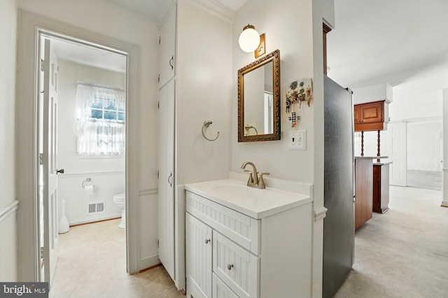 bathroom featuring visible vents, vanity, and toilet