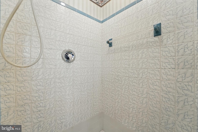 bathroom with tiled shower