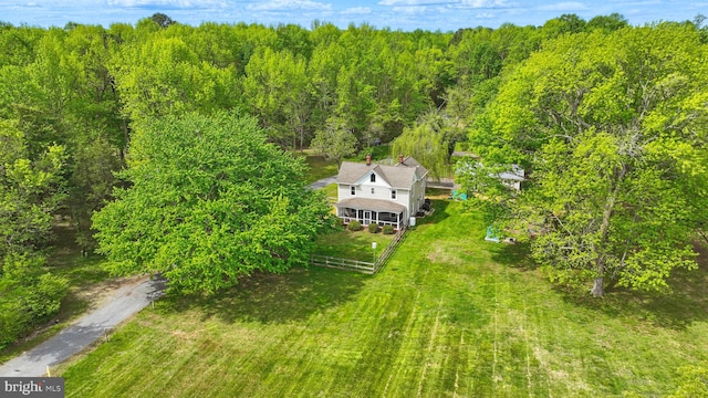 birds eye view of property with a wooded view