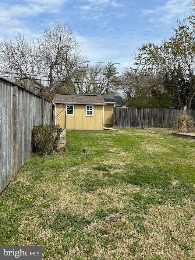 view of yard featuring an outbuilding and a fenced backyard