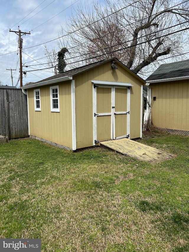 view of shed with fence