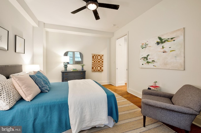 bedroom with baseboards, a ceiling fan, and wood finished floors