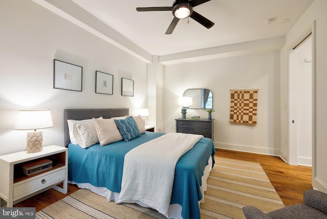 bedroom featuring baseboards, ceiling fan, and wood finished floors