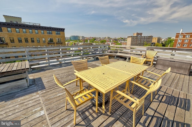 wooden deck featuring a view of city and outdoor dining area