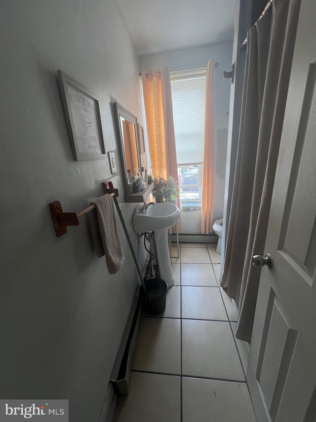 6700 Marsden St, Philadelphia, PA 19135 - full bathroom featuring a baseboard heating unit, toilet, and tile patterned floors