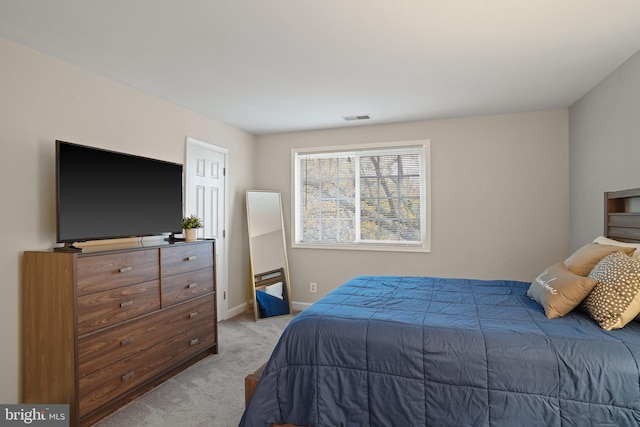 bedroom featuring visible vents, baseboards, and carpet