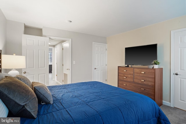 carpeted bedroom featuring baseboards