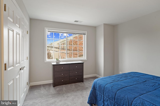 bedroom with visible vents, light colored carpet, and baseboards