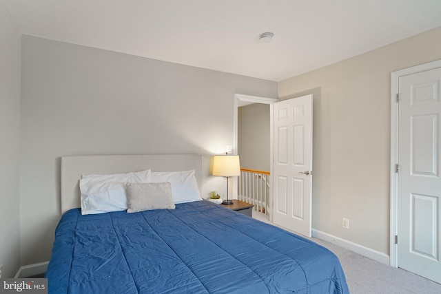 carpeted bedroom featuring baseboards