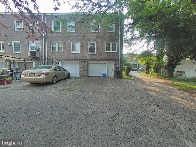 2710 N 47th St, Philadelphia, PA 19131 - view of front of house with a garage, brick siding, and driveway