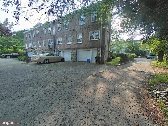 2710 N 47th St, Philadelphia, PA 19131 - view of property featuring an attached garage, driveway, and cooling unit