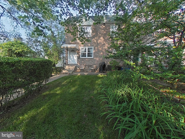 2710 N 47th St, Philadelphia, PA 19131 - view of front of house with brick siding, entry steps, and a front lawn
