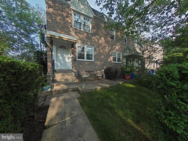 2710 N 47th St, Philadelphia, PA 19131 - view of front facade with brick siding, a high end roof, entry steps, and a patio