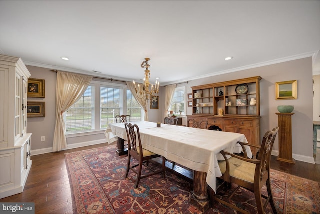 dining area with dark wood-style floors, baseboards, an inviting chandelier, and ornamental molding