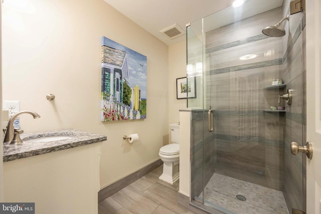 full bathroom with vanity, visible vents, toilet, a stall shower, and baseboards