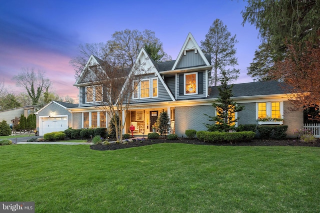 craftsman-style house featuring brick siding, a front yard, covered porch, and board and batten siding