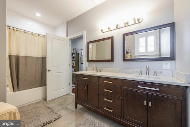 full bath featuring a sink, tile patterned floors, double vanity, and shower / bath combo with shower curtain