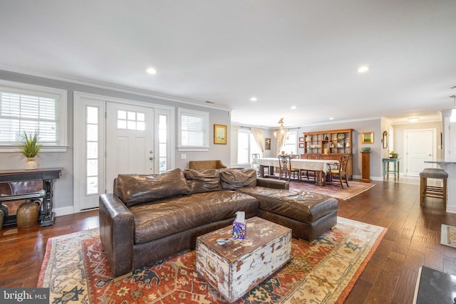 living area featuring crown molding, recessed lighting, and dark wood finished floors