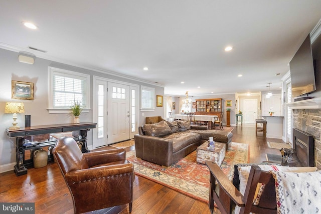 living area with crown molding, visible vents, recessed lighting, and hardwood / wood-style floors