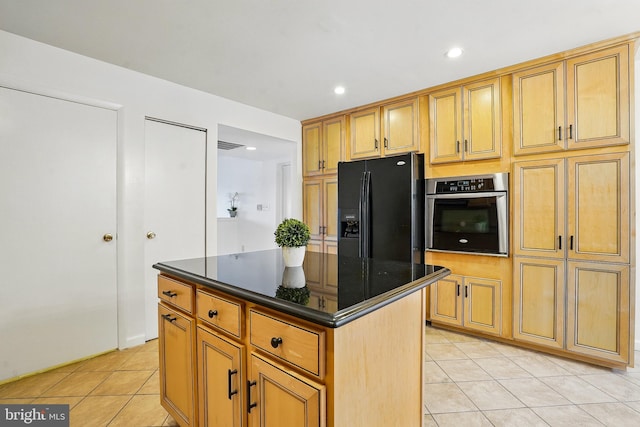 kitchen featuring black fridge with ice dispenser, recessed lighting, stainless steel oven, a center island, and light tile patterned floors