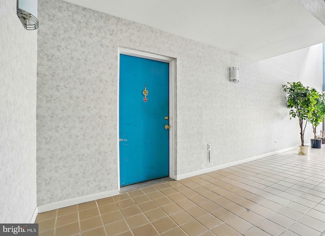 entrance to property featuring stucco siding