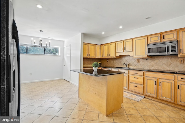 kitchen featuring stainless steel microwave, light tile patterned floors, black electric stovetop, refrigerator with ice dispenser, and a sink