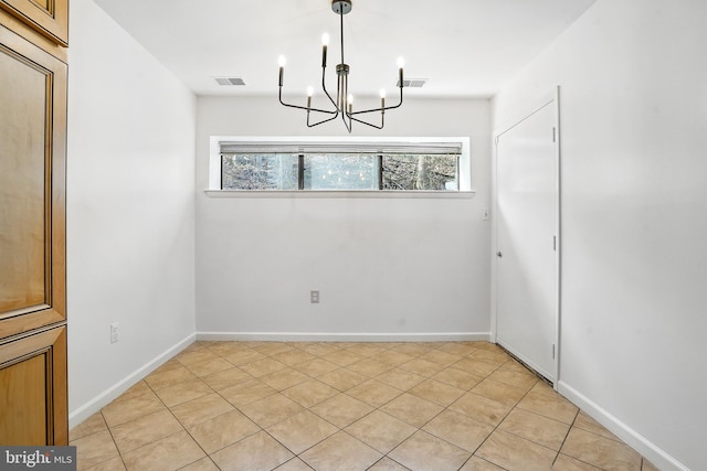 unfurnished dining area with baseboards, visible vents, and a notable chandelier