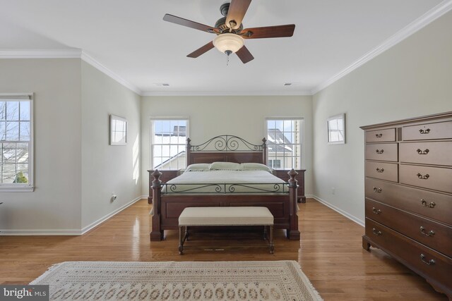 bedroom with baseboards, ornamental molding, and light wood-type flooring
