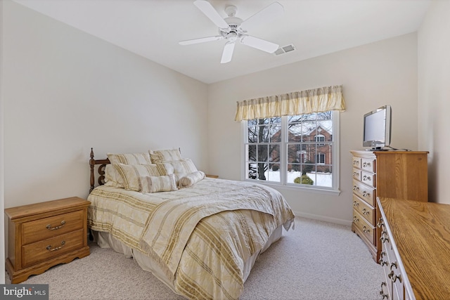 bedroom featuring baseboards, ceiling fan, light carpet, and visible vents