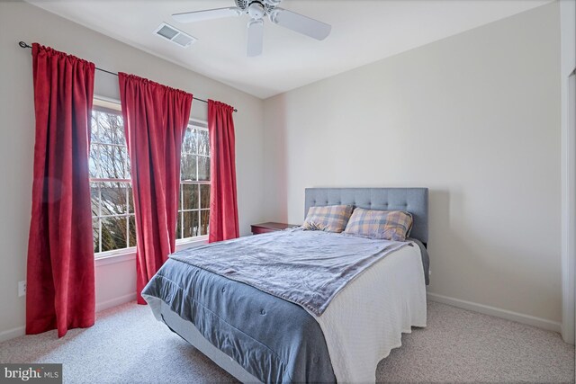 bedroom with visible vents, a ceiling fan, baseboards, and carpet floors