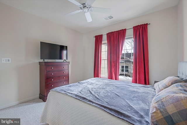 carpeted bedroom featuring visible vents, baseboards, and ceiling fan