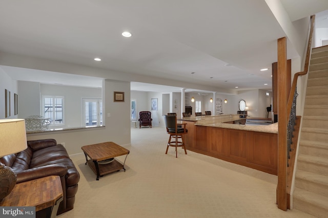 bar with decorative columns, decorative light fixtures, stairs, light carpet, and recessed lighting