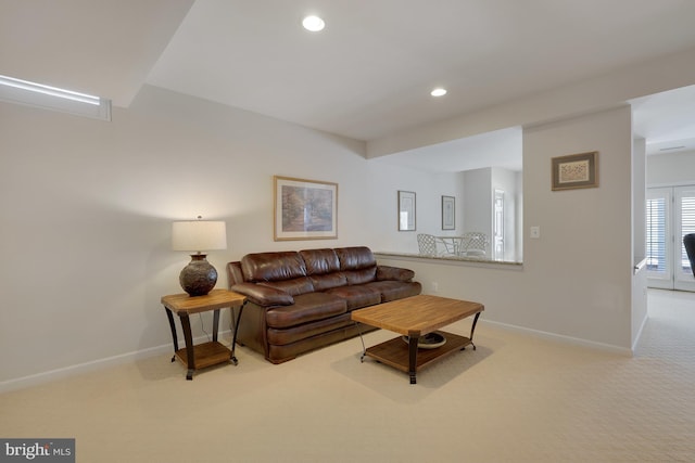 carpeted living area with recessed lighting and baseboards