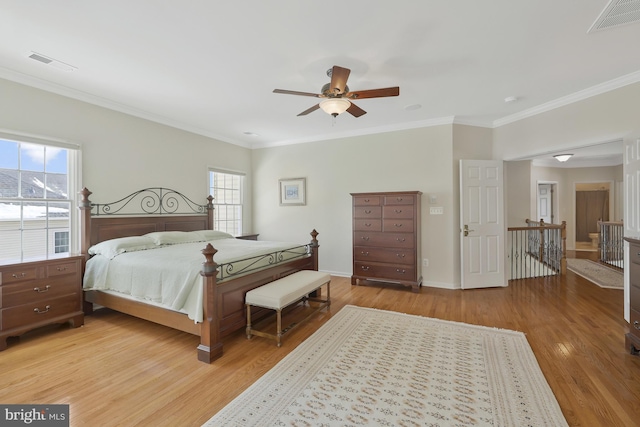 bedroom with visible vents, multiple windows, and light wood-style floors