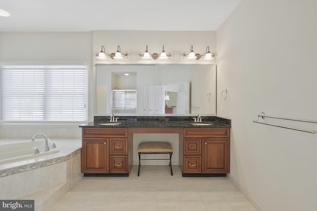 bathroom featuring double vanity, a sink, tile patterned flooring, and a garden tub