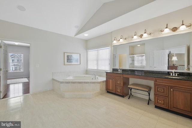 full bathroom with a garden tub, a sink, vaulted ceiling, and a shower stall