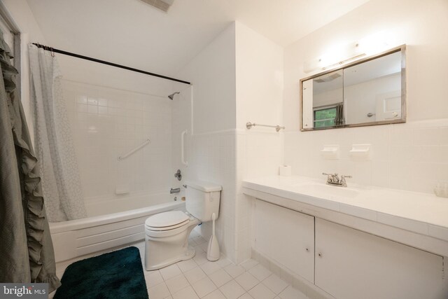 304 King Rd, West Chester, PA 19380 - full bath featuring tile patterned flooring, tile walls, shower / bath combo with shower curtain, and toilet