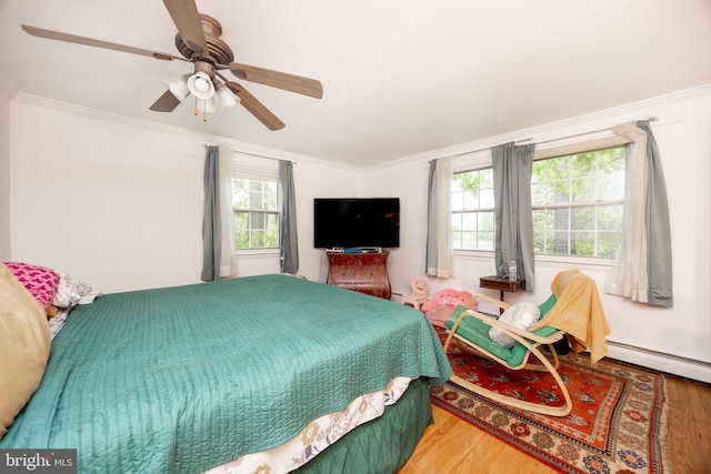 304 King Rd, West Chester, PA 19380 - bedroom featuring multiple windows, ornamental molding, ceiling fan, and wood finished floors