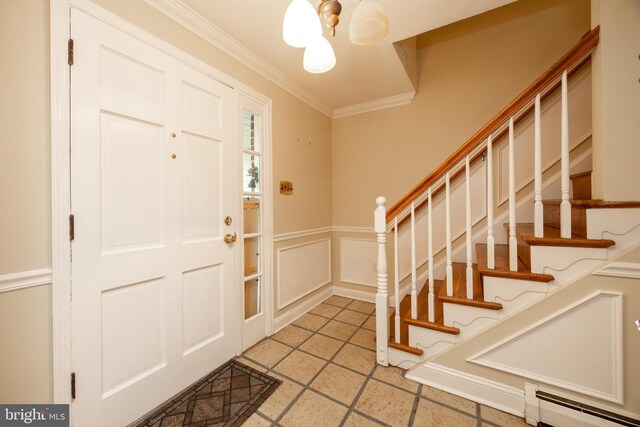 304 King Rd, West Chester, PA 19380 - entryway featuring a baseboard radiator, a decorative wall, crown molding, a wainscoted wall, and stairway