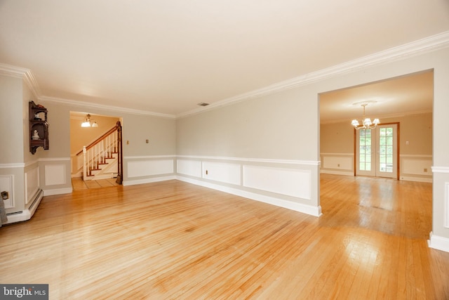 304 King Rd, West Chester, PA 19380 - unfurnished living room featuring stairway, ornamental molding, a notable chandelier, and light wood-type flooring