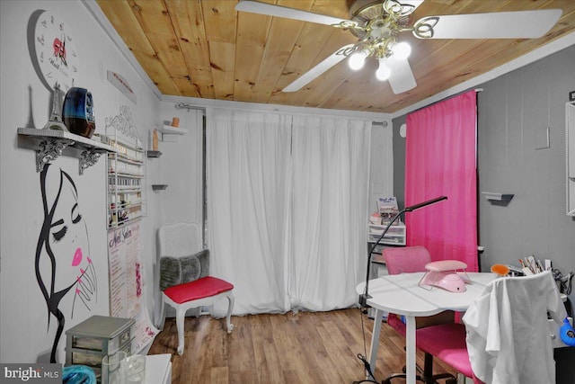 misc room featuring crown molding, wood finished floors, wood ceiling, and a ceiling fan