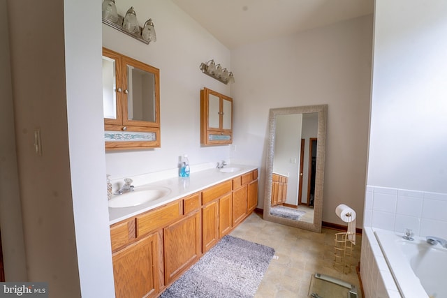 bathroom featuring a garden tub, a sink, and double vanity