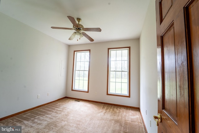 unfurnished room featuring ceiling fan, baseboards, visible vents, and carpet floors