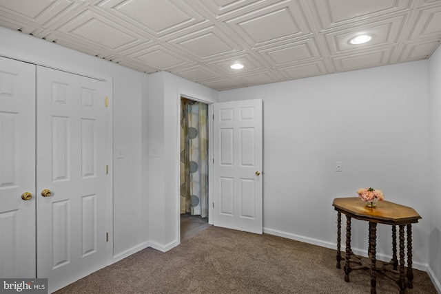 interior space featuring recessed lighting, dark colored carpet, and baseboards