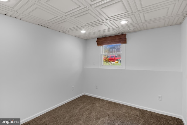 interior space featuring recessed lighting, an ornate ceiling, baseboards, and dark carpet